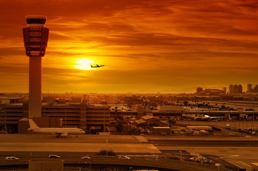 Aviation Security Consulting and Training By Chameleon Associates airport control tower and airplane taking off at sunset
