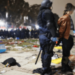 An officer apprehends a violent protestor on campus.
