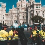 Police gather in a city square to control crowds.