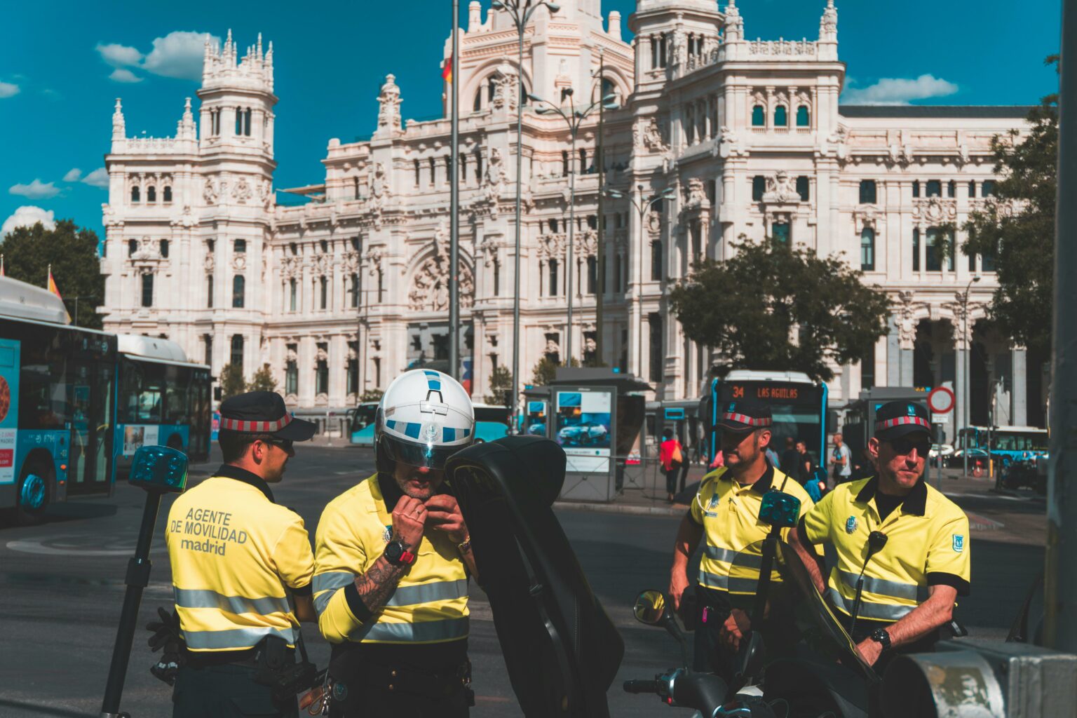 Police gather in a city square to control crowds.