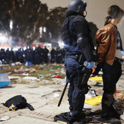 An officer apprehends a violent protestor on campus.